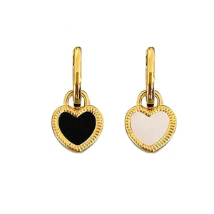 Vintage gold heart earrings with black and white enamel finish in a minimalist style