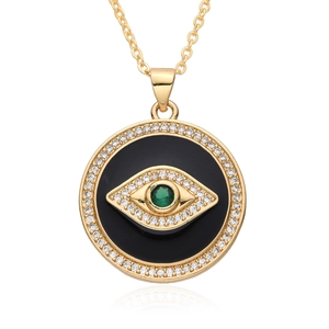 Detail of evil eye necklace with green gemstone and sparkling zircon in golden frame