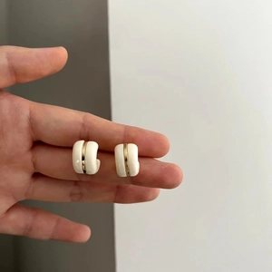 Minimalist C-shaped off-white enamel hoop earrings with gold metal stripe accent