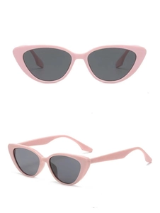 Detail view of pink cat eye sunglasses with dark grey UV lenses and glossy finish