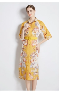 Detail of yellow floral midi dress featuring a shirt collar and matching square buckle belt