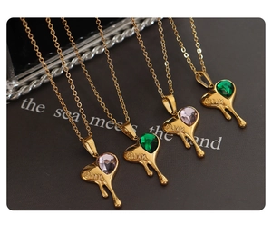 Close-up of heart lava pendants with pink and green zircon and Dream engraving