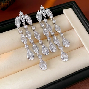 Detailed macro of silver tassel earrings featuring marquise and teardrop zircon stones