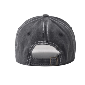 Detail view of washed cotton baseball cap showing contrast stitching and metal buckle