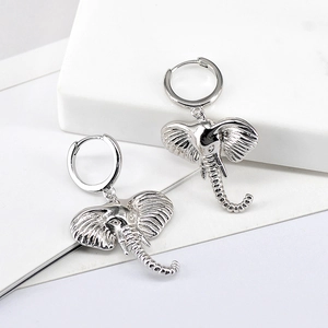 Detailed close-up of S925 silver elephant hoop earrings with realistic skin texture details