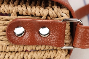 Detailed macro view of woven fiber texture with brown lychee leather trim and silver rivets