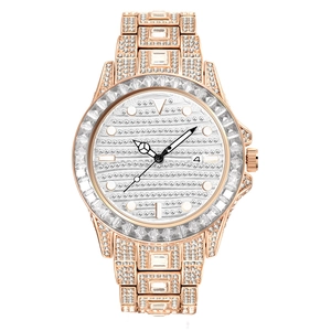 Macro shot of rose gold watch bezel with rainbow crystals and full iced out stone setting