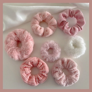 Set of 7 plush hair scrunchies in varied textures like faux fur and corduroy in pink tones