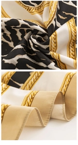 Detail shot of leopard print faux silk scarf showing hemmed edges and chain pattern