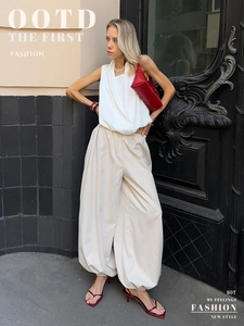 Chic street style outfit featuring white wide-leg pleated harem pants with red accessories