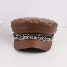 Detail view of brown faux leather leopard military hat with silver decorative chain