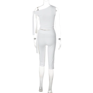 Rear view of white one-shoulder crop top and slim-fit capri pants on mannequin
