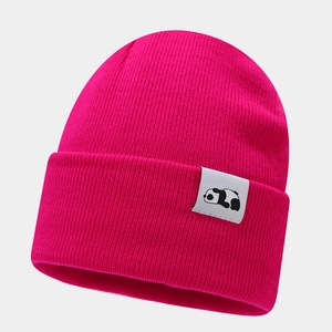 Detailed knit texture of hot pink winter beanie featuring a cute panda patch logo