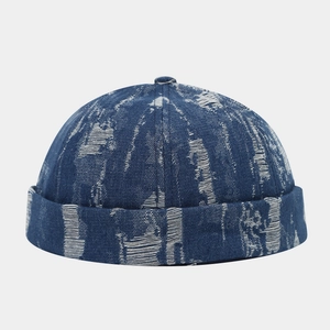 Close-up of dark blue denim docker hat with white distressed details and top button