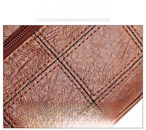 Detail of brown lychee grain leather handbag with contrast stitching and metal zipper
