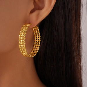 Side view of model wearing 18K gold plated chunky braided C-shape hoop earrings