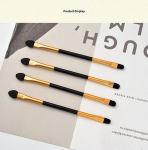 Close-up of dual-ended eyeshadow brushes with sponge tips and synthetic bristles