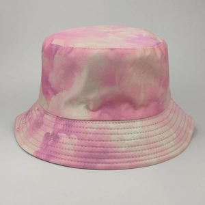 Detailed view of pink tie-dye pattern and fabric texture on a reversible bucket hat