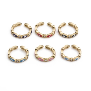 Detail of six evil eye gold rings with colorful enamel and sparkling zircon accents
