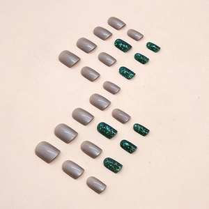 Short square press-on nails set in dark green glitter and aurora purple cat-eye finish