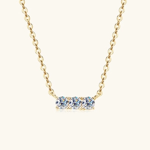 Detailed close-up of gold S925 sterling silver necklace with three round sparkling moissanite stones
