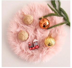 Detailed top view of pink faux fur Christmas tree skirt with plush texture and pine decor