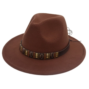 Detail of dark brown fedora with leather band, metal accents and shell decorations