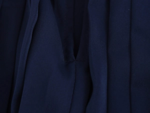 Detailed macro view of deep blue satin fabric texture and premium stitching details
