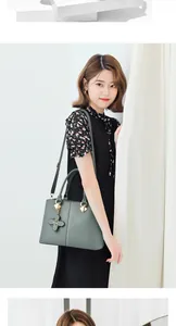 Detailed view of Morandi green leather handbag with clover charm and gold hardware
