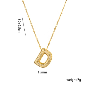 Macro detail of 18K gold plated letter D pendant with micro-pave zircons and dimensions