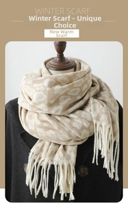 Detail of winter leopard jacquard scarf with fringe trim paired with tweed coat