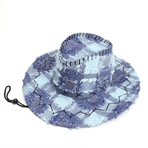 Detail of blue denim patchwork cowboy hat with frayed edges and contrast stitching