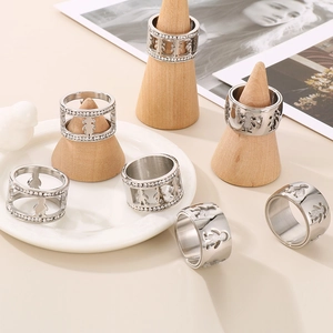 Silver hollow figure cutout rings with sparkling diamonds in a minimalist aesthetic