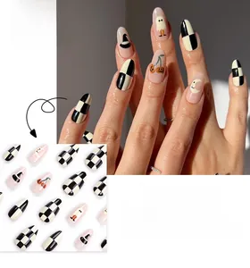 Detail of Halloween almond press-on nails featuring checkerboard and ghost patterns