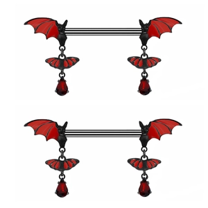 Close-up of black bat nipple rings with red teardrop rhinestones on white background