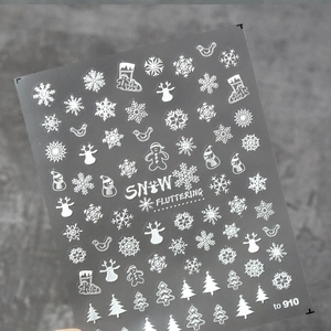 Detail view of 5D white embossed nail stickers featuring snowflakes and reindeer patterns