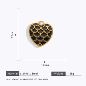Detail showing dimensions of 18k gold plated heart charm with black scale texture