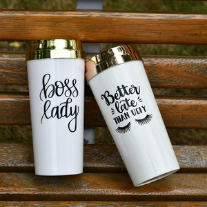 Double-layer acrylic coffee tumblers with BOSS LADY text on a wooden bench