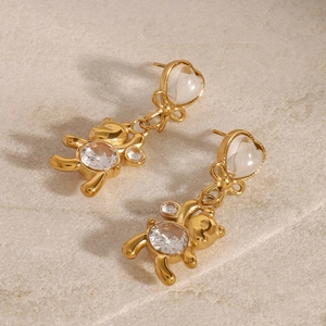 Boucles d'oreilles ours dorées en acier avec nœud papillon et détails zircons
