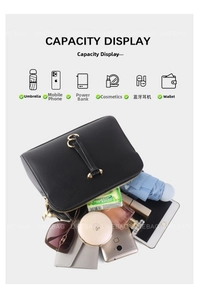 Detail showing the large capacity of the black pebbled leather bag with daily essentials