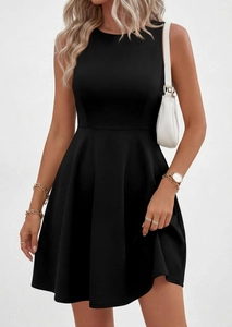 Detail of a black sleeveless high-neck mini dress with an A-line pleated skirt and cinched waist