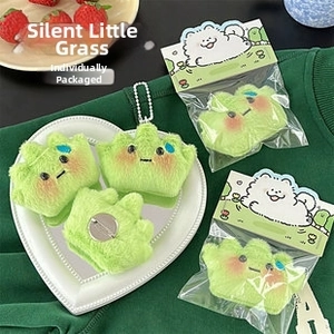 Detail of green plush clip featuring a funny expression and cute packaging for bags