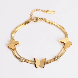Close-up of golden double-layer stainless steel bracelet with frosted butterflies