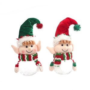 Christmas elf candy jars in red and green with plush decorations on clear plastic bottles