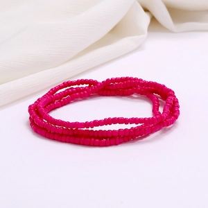 Detailed macro shot of layered handmade pink seed bead strands for beach waist chains