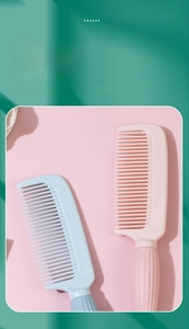 Close-up detail of pink and blue wide-tooth hair combs for daily household hair care.