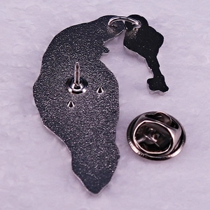 Glittery raven enamel pin with key pendant and butterfly clutch on silver metallic back