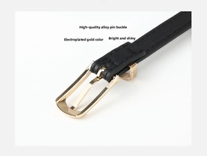 Detail of high-quality alloy pin buckle in gold plating on a slim black leather belt