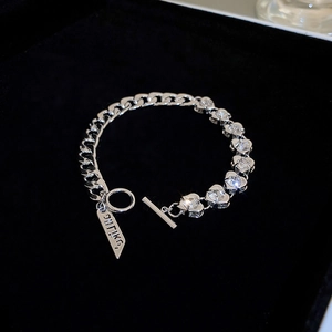 Detailed macro of silver OT buckle chain bracelet with heart-shaped crystal inlay