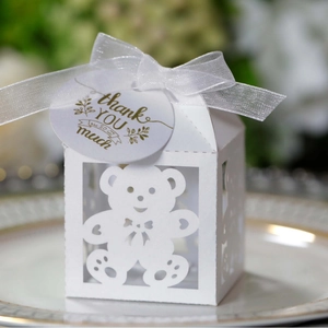 White laser-cut baby shower candy box with bear pattern and thank you tag